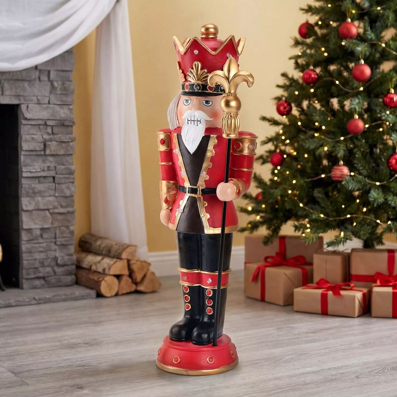 A tall nutcracker soldier beside a Christmas tree