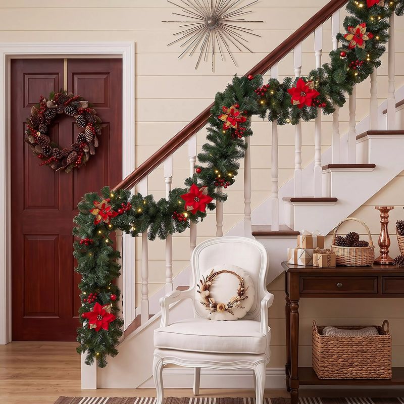 A Christmas wreath on a front door with a matching garland on the stairs