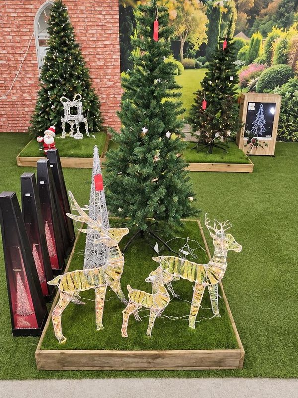 Gold light-up reindeer and artificial trees