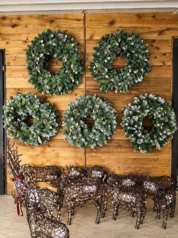 Wreaths on display with rattan reindeer