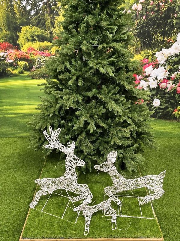 A tall artificial tree with light-up reindeer